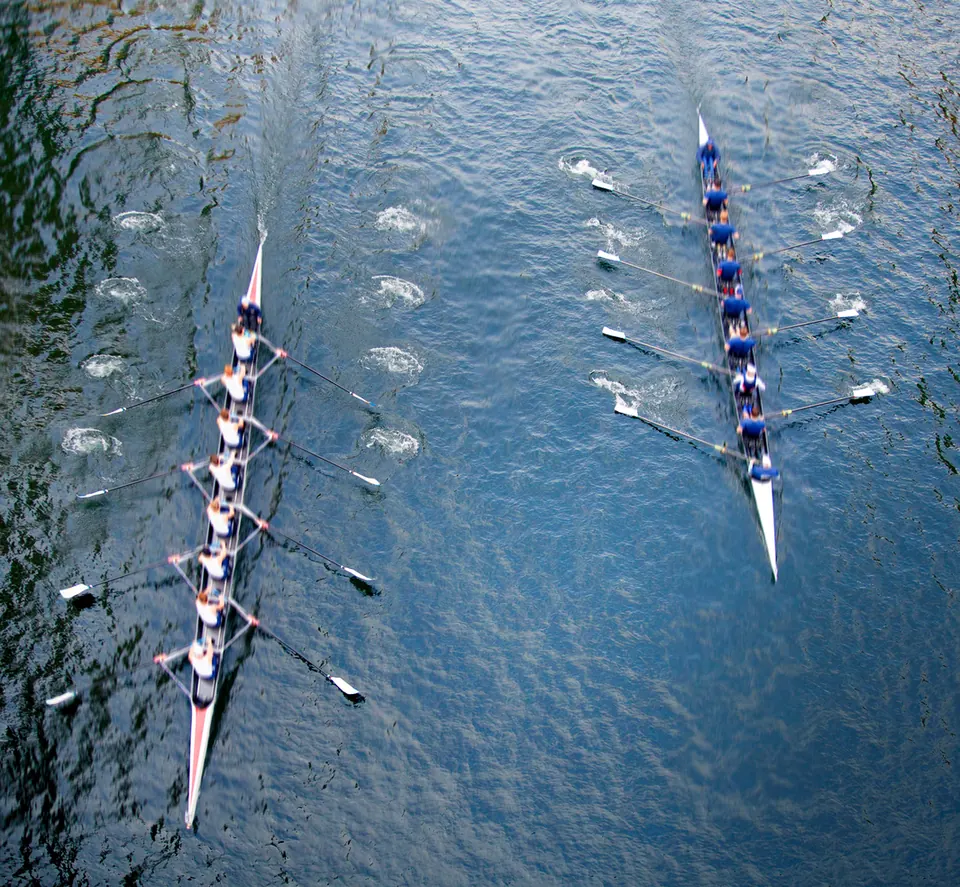 Rowing team moving together on the water