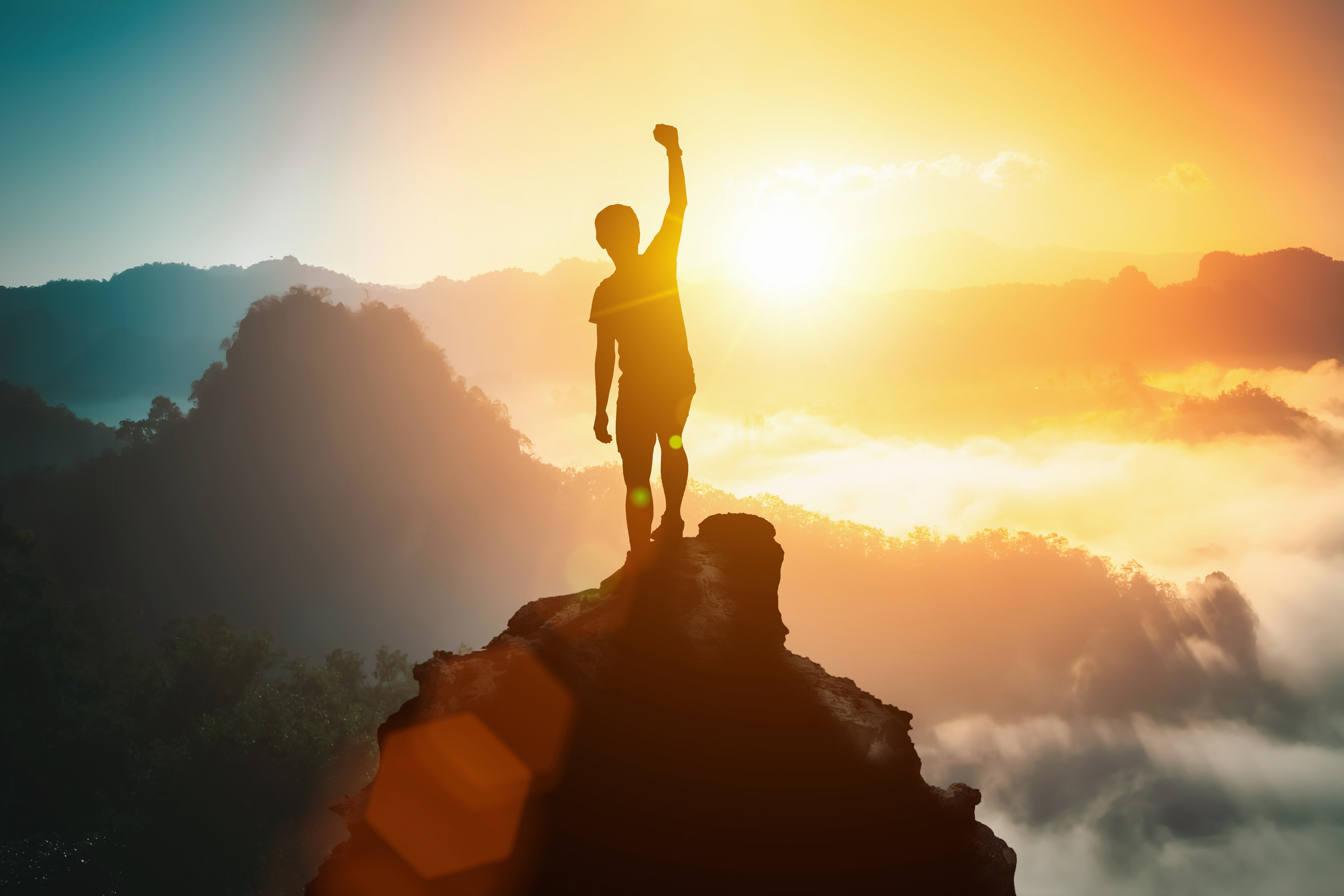 Person on the top of the mountain celebrating