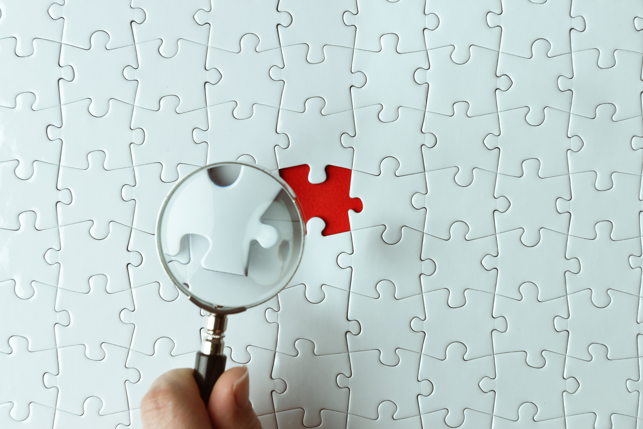 Magnifying glass over a missing puzzle piece